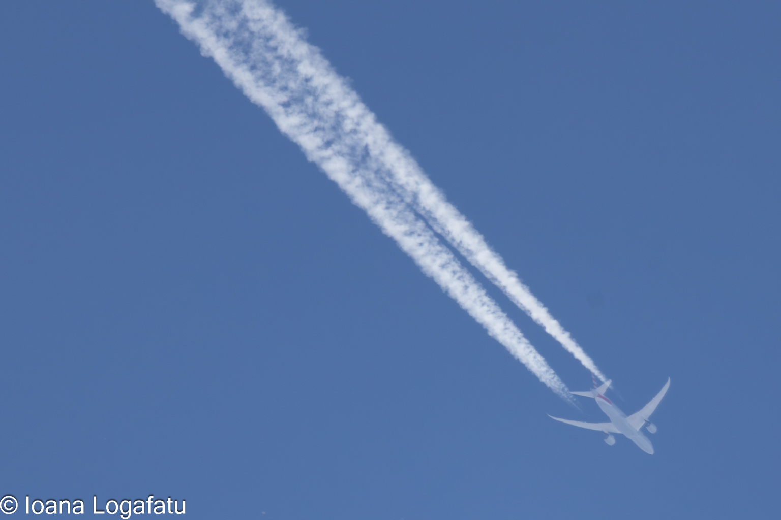 Jet flying high with vapor trails
